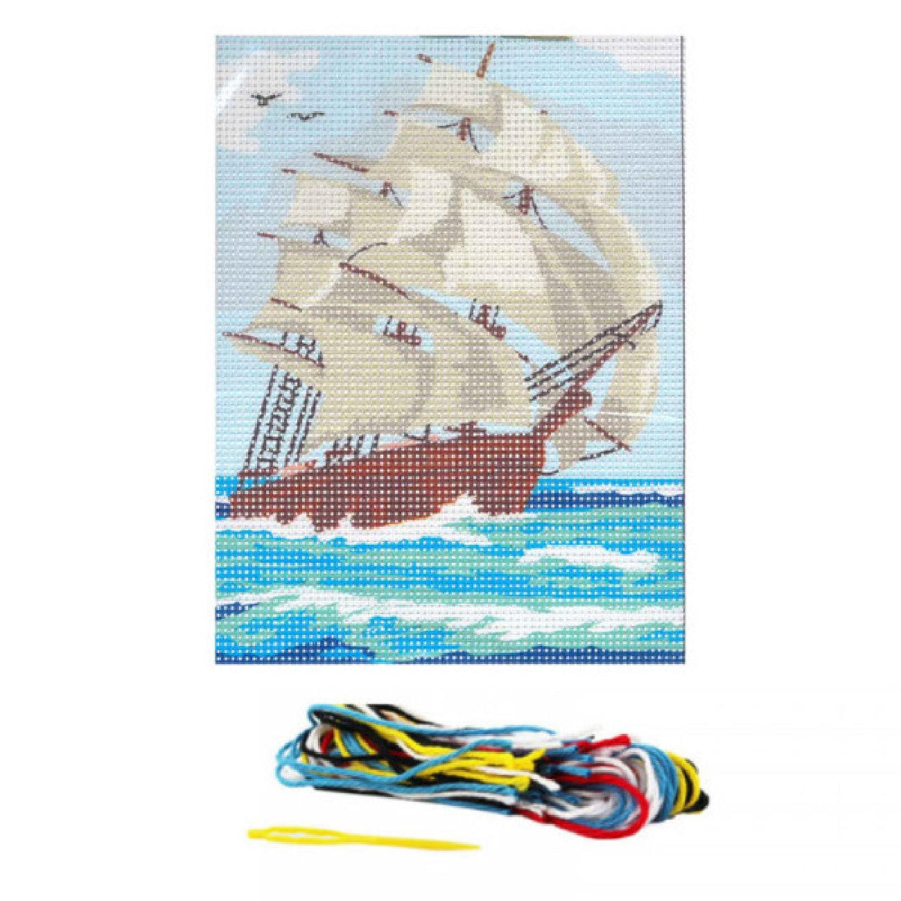 pack canevas contenant une toile imprimée avec un bateau voilier, des fils, une aiguille et la noticle. Canocea France